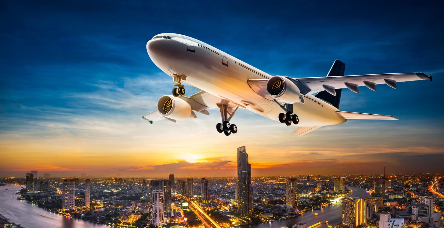 Aircraft taking off over a city at dusk