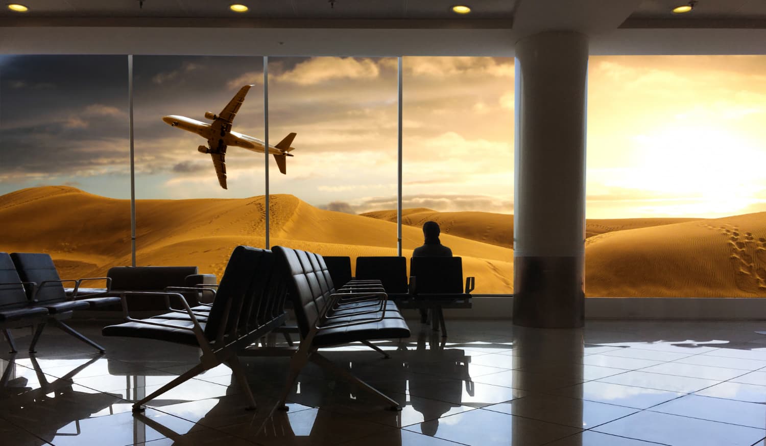 Business travellers in an airport terminal at sunset
